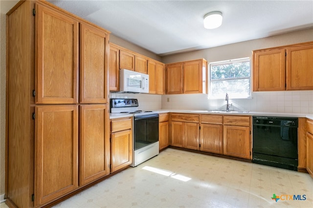 kitchen featuring tasteful backsplash, sink, and white appliances