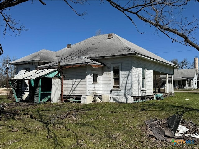 view of side of home with a lawn