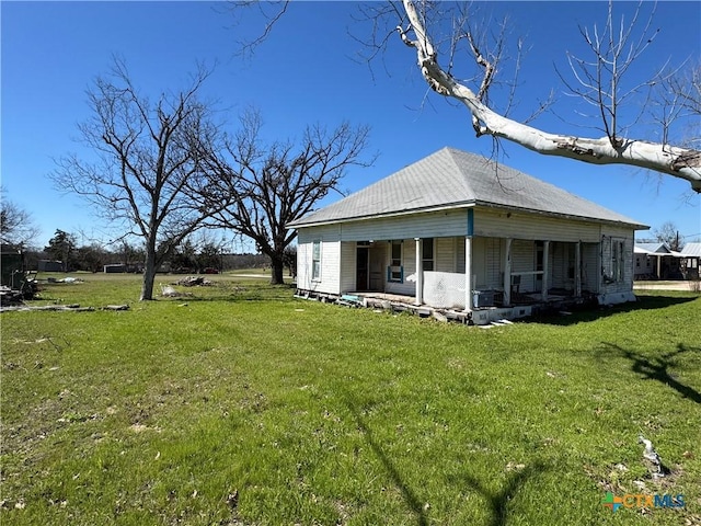 rear view of property with a yard