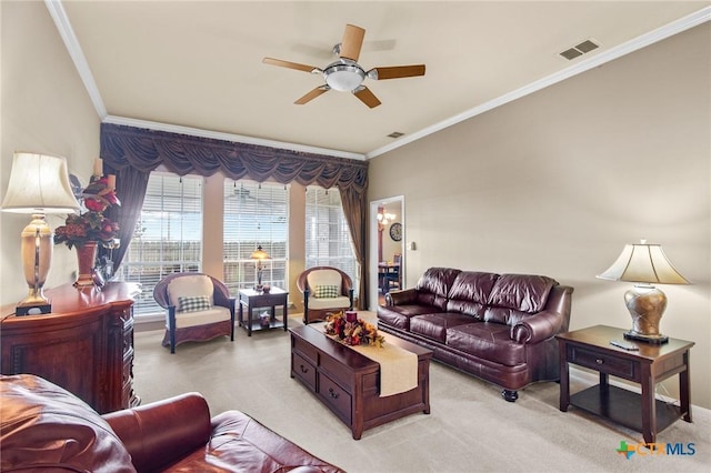 living area featuring light carpet, a ceiling fan, visible vents, and ornamental molding