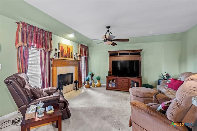living room with a fireplace, carpet, and ceiling fan
