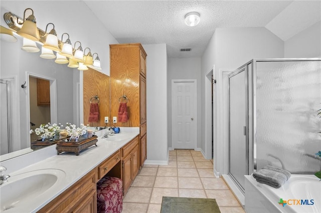 full bathroom featuring double vanity, a shower stall, and a sink