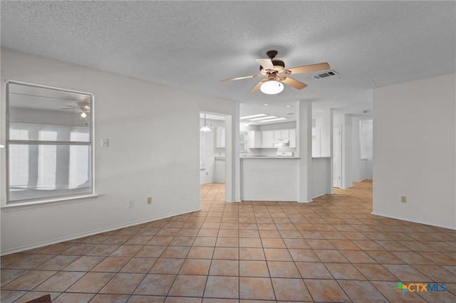 unfurnished living room featuring a textured ceiling, ceiling fan, and visible vents