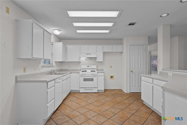kitchen featuring visible vents, white appliances, light countertops, under cabinet range hood, and a sink