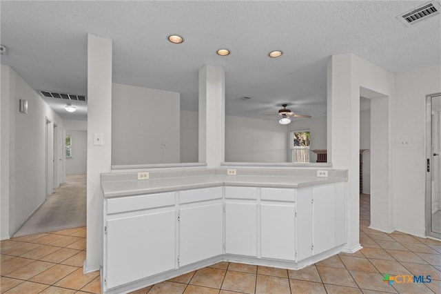 kitchen featuring light countertops, a ceiling fan, light tile patterned flooring, and visible vents