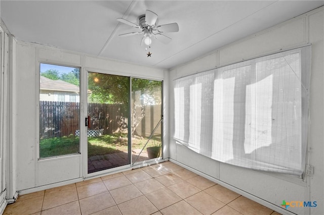 unfurnished sunroom with ceiling fan