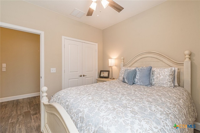 bedroom featuring ceiling fan, a closet, and dark hardwood / wood-style floors