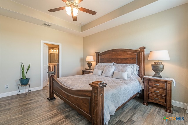 bedroom with connected bathroom, ceiling fan, and dark wood-type flooring