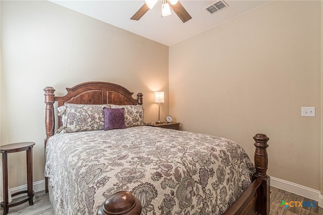 bedroom with ceiling fan, wood-type flooring, and vaulted ceiling