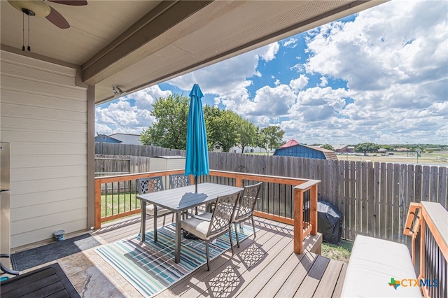 wooden terrace featuring ceiling fan