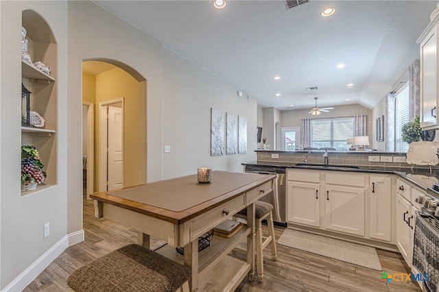 kitchen with white cabinetry, sink, ceiling fan, stainless steel appliances, and light wood-type flooring