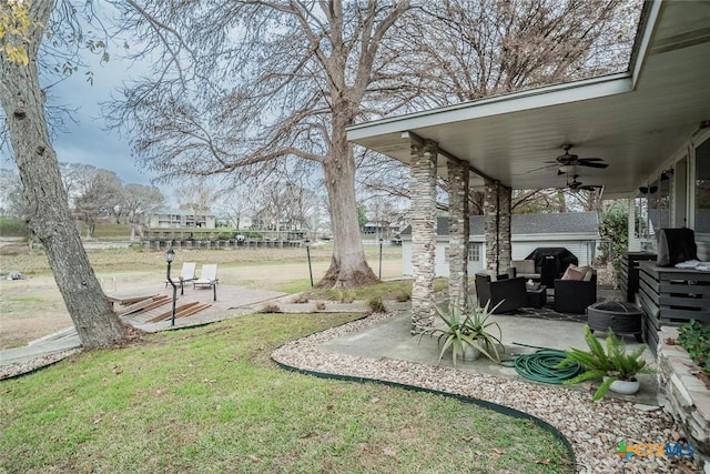 view of yard featuring a patio area and ceiling fan