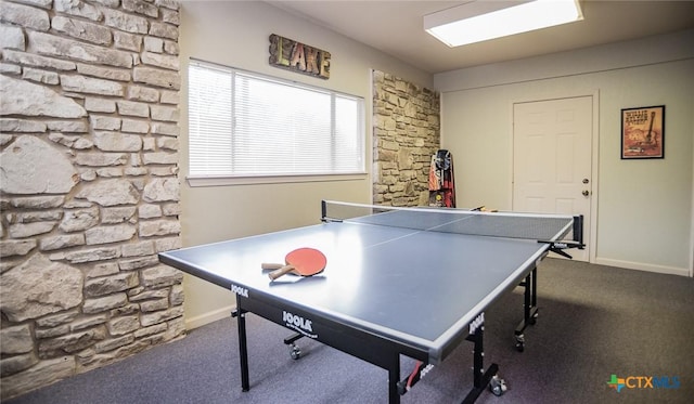 recreation room with dark carpet