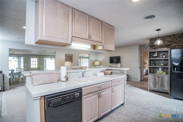 kitchen featuring sink, hanging light fixtures, light brown cabinets, and black appliances