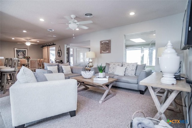 living room with carpet and ceiling fan