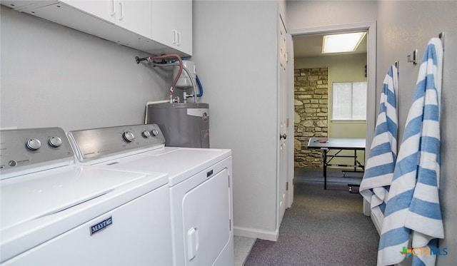 laundry area featuring cabinets, light colored carpet, water heater, and washing machine and clothes dryer