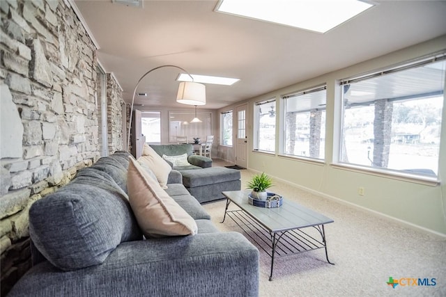 living room with light carpet and a skylight