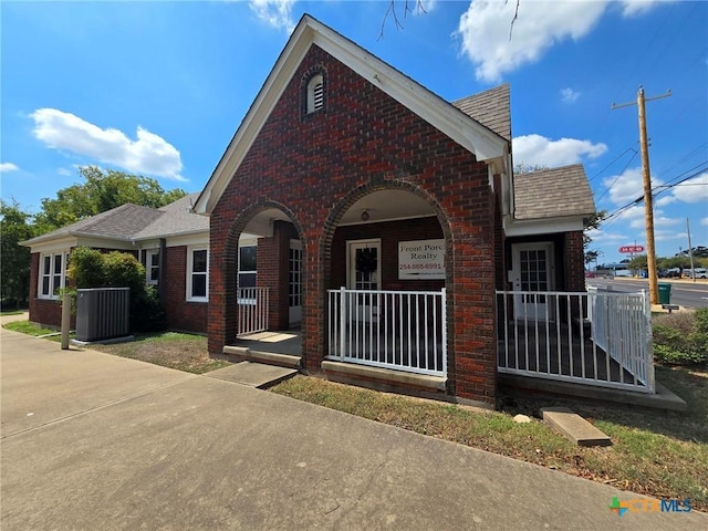 view of front of home with covered porch and central air condition unit