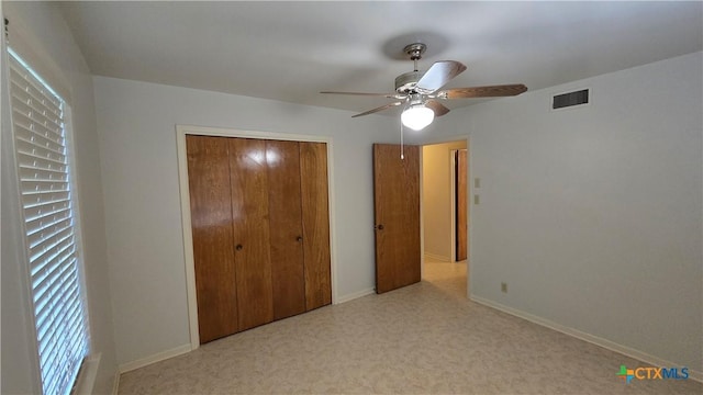 unfurnished bedroom featuring visible vents, baseboards, a ceiling fan, and a closet