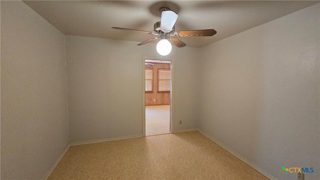 spare room featuring baseboards and a ceiling fan