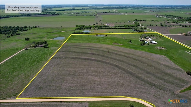 birds eye view of property with a rural view