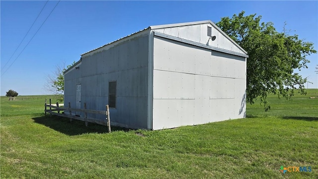 view of pole building with a yard and fence