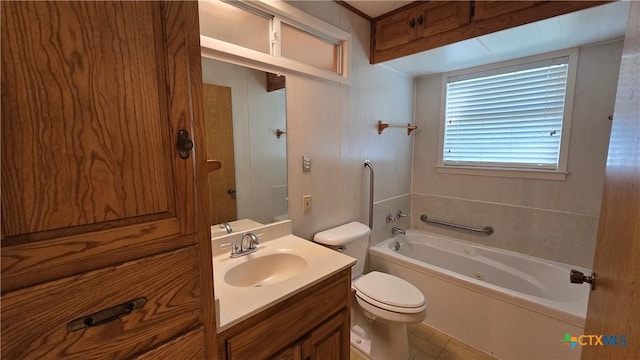 bathroom with vanity, a tub, and toilet