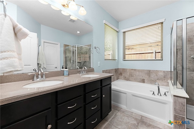 bathroom with independent shower and bath, vanity, and tile patterned floors