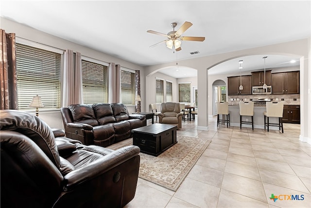 living room with light tile patterned floors and ceiling fan