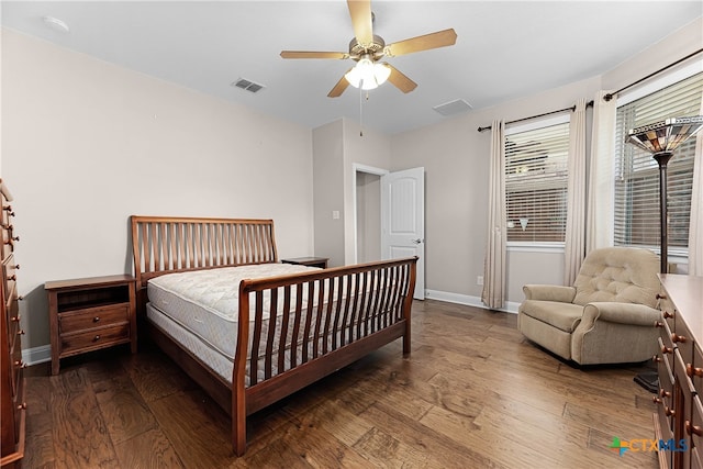 bedroom with ceiling fan and dark hardwood / wood-style floors