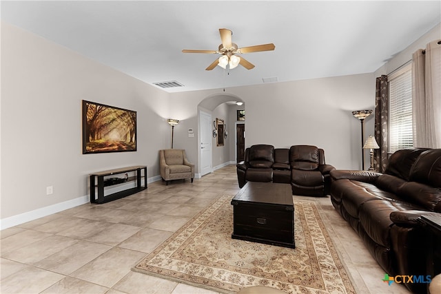 tiled living room with ceiling fan