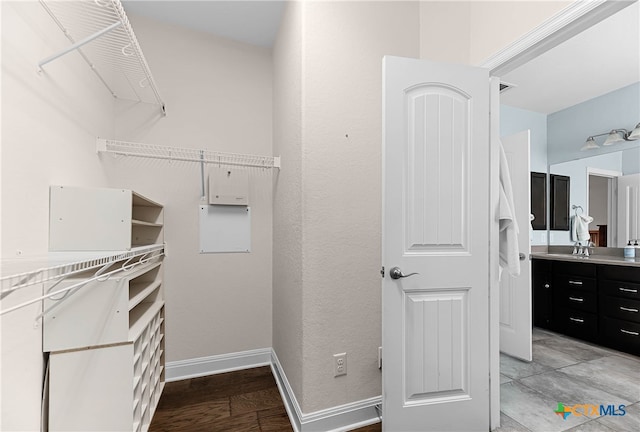 spacious closet featuring light hardwood / wood-style flooring and sink