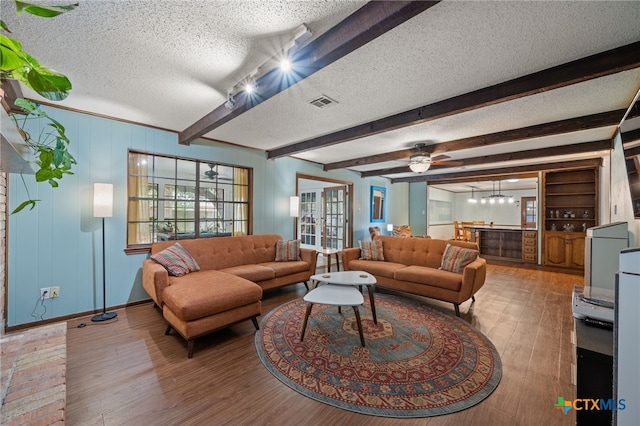 3909 Alderwood Ln, Temple, TX 76502 - living area featuring a textured ceiling, wood finished floors, beam ceiling, and baseboards