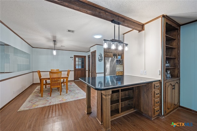 3909 Alderwood Ln, Temple, TX 76502 - kitchen featuring stainless steel appliances, dark wood-type flooring, a textured ceiling, beamed ceiling, and dark countertops