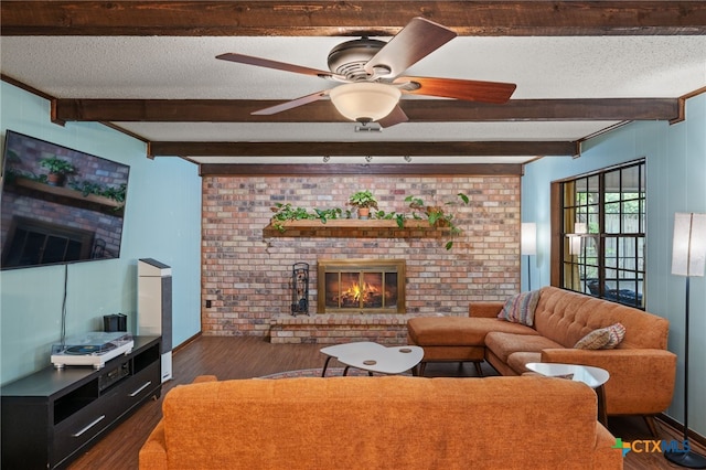 3909 Alderwood Ln, Temple, TX 76502 - living room featuring beamed ceiling, dark wood-style flooring, a fireplace, a textured ceiling, and ceiling fan
