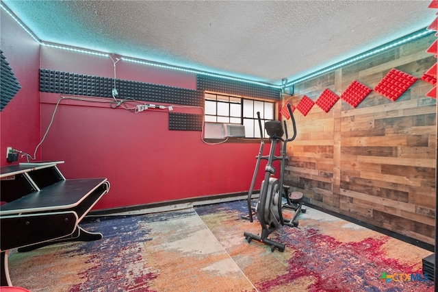 3909 Alderwood Ln, Temple, TX 76502 - workout area featuring a textured ceiling, cooling unit, and wooden walls