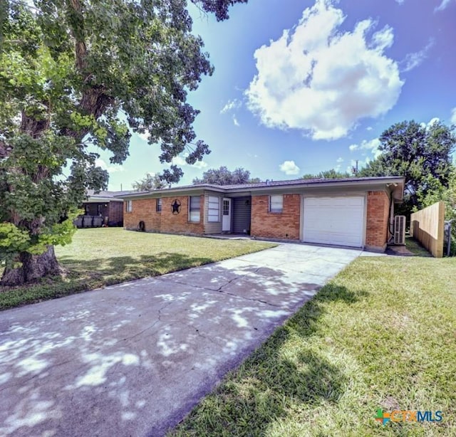 3207 Linda Dr, Victoria, TX 77901 - ranch-style home with driveway, an attached garage, and brick siding