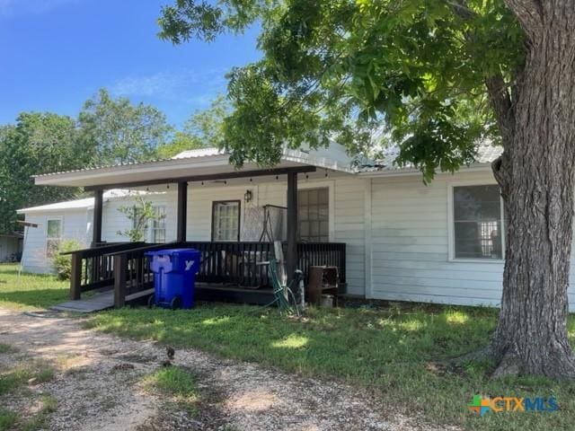 back of property featuring a porch
