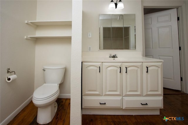 1004 Estes Dr, Killeen, TX 76541 - bathroom featuring baseboards, wood finished floors, toilet, and vanity