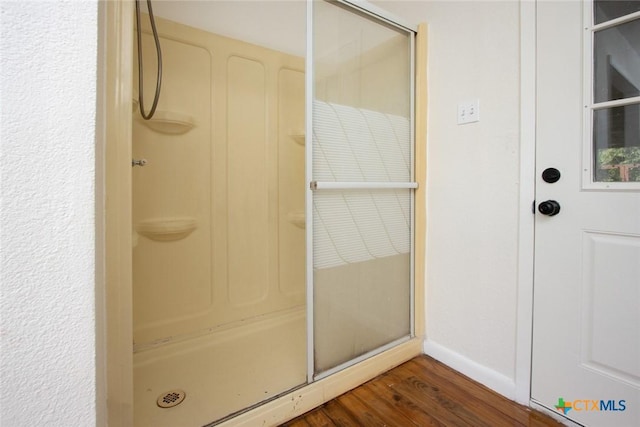 1004 Estes Dr, Killeen, TX 76541 - full bathroom featuring a shower, wood finished floors, and baseboards