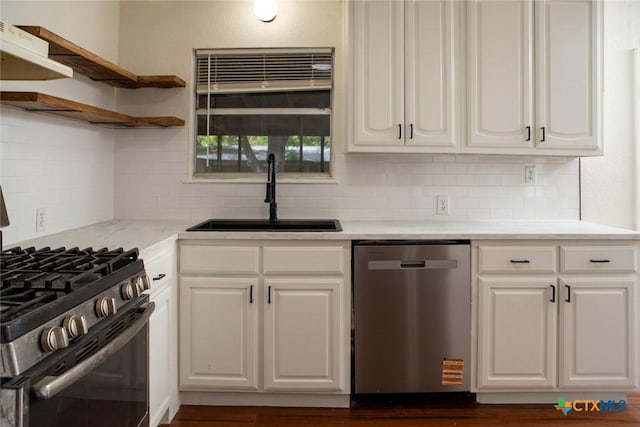 1004 Estes Dr, Killeen, TX 76541 - kitchen featuring white cabinetry, decorative backsplash, stainless steel dishwasher, a sink, and range with gas cooktop