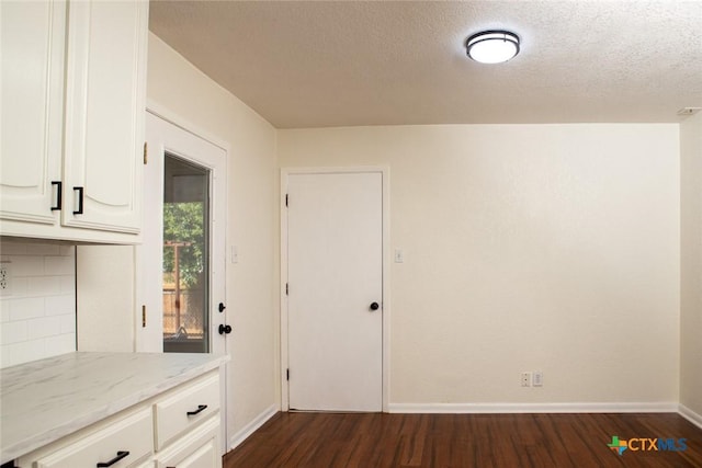 1004 Estes Dr, Killeen, TX 76541 - interior space with a textured ceiling, baseboards, and dark wood finished floors