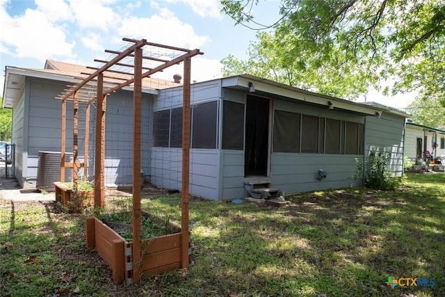 1004 Estes Dr, Killeen, TX 76541 - exterior space featuring a lawn, a garden, a pergola, and a sunroom