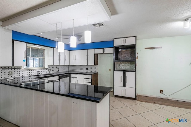 kitchen featuring backsplash, decorative light fixtures, kitchen peninsula, and white cabinets