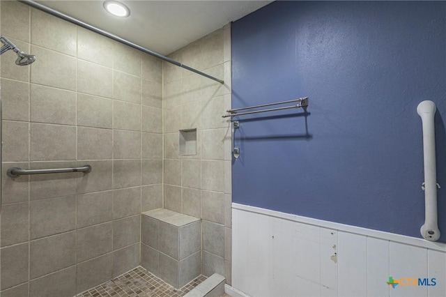 bathroom with a tile shower