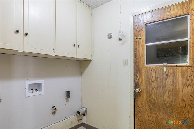 clothes washing area featuring cabinets and washer hookup