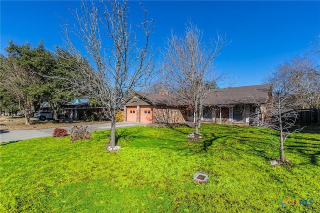 view of front of home with a garage and a front yard