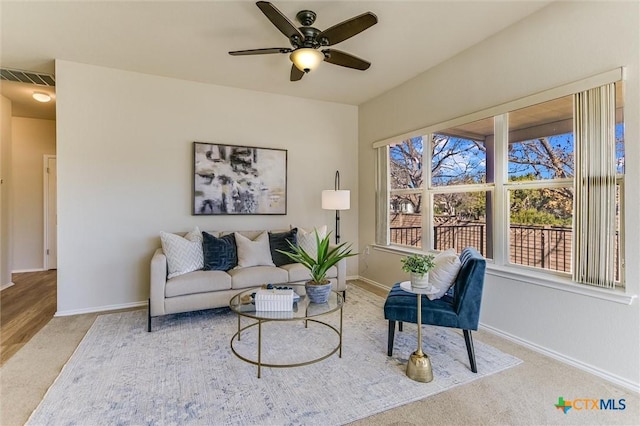 living room featuring ceiling fan and carpet flooring