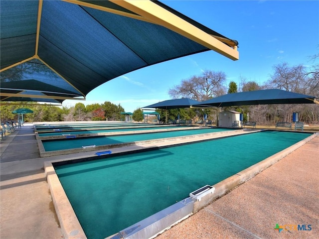 view of pool with a shed