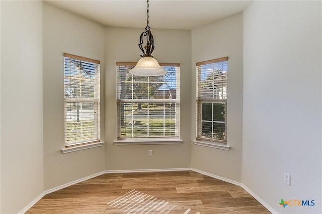 unfurnished dining area featuring light hardwood / wood-style floors